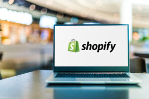 Laptop computer displaying logo of Shopify